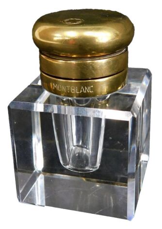 A Mont Blanc inkwell, with brass top, on square glass base, with logo and company name, 6.5cm high, 4cm x 4cm.