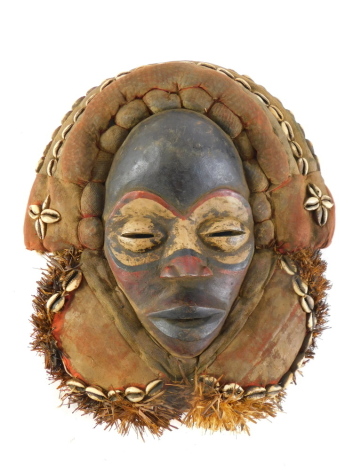 A spiritual harvest celebration mask with mudcloth and cowrie shells, Cote D'Ivoire, 36cm high.