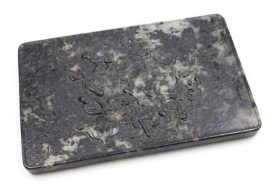 A 19thC Qing dynasty Chinese mottled black jade panel, possibly for a table screen, of rectangular section, decorated in relief with the Immortal Han Zhonglu, riding a donkey, and accompanied by four boys serving wine, 16cm high, 24.5m wide.