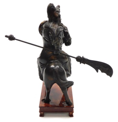 A 20thC Chinese bronze figure of Guan Yu, modelled on horseback, holding a guandao, on a wooden stand, 31cm high. - 5