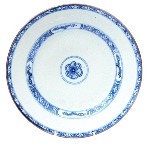 An 18thC Qing dynasty blue and white plate, an hua decorated with stylised flowers, within hatched borders, 22.5cm wide.