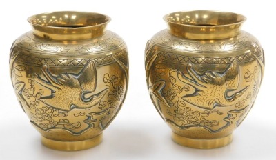 A pair of early 20thC Chinese heavy brass vases, embossed with a deer, bamboo, trees and a crane, the bases with seal script marks on wooden stands, 19.5cm high. - 2