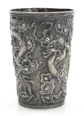 A Hung Chong silver beaker, repousse decorated with dragons chasing a flaming pearl, with a circular reserve engraved with a coronet and monogram, engraved to base Schnitzler S Kasino 1900-01, no 282, two character and HC marks, 2.87oz, 8.5cm high. - 3