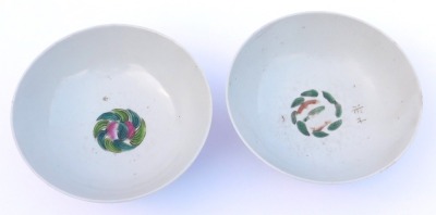 Two 20thC Chinese famille rose porcelain bowls, one painted with flowers, internally with fruit, printed seal mark, 15.5cm wide, the other with a garden, internally with fruit, 15.5cm wide, (2) - 6