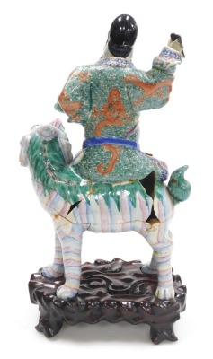 A 19thC Qing dynasty famille verte porcelain figure group, modelled as the Immortal Fuxing seated upon a Foo dog, raised on a wooden stand, 39cm high all in. (AF) - 3