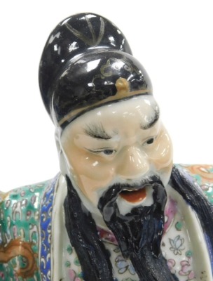 A 19thC Qing dynasty famille verte porcelain figure group, modelled as the Immortal Fuxing seated upon a Foo dog, raised on a wooden stand, 39cm high all in. (AF) - 5