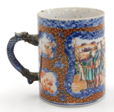 A Qianlong famille rose porcelain tankard, with a dragon handle, painted with reserves of figures in a garden, birds and flowers, within a blue floral ground, 11cm high, together with an early 19thC blue and white, and clobbered chinoiserie saucer, 14cm w - 7