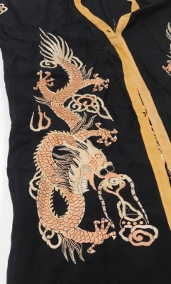 An early 20thC Chinese black silk short surcoat, embroidered with dragons in pink and white, with peach trim. - 2