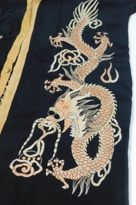 An early 20thC Chinese black silk short surcoat, embroidered with dragons in pink and white, with peach trim. - 3