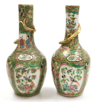 A pair of early 19thC Qing dynasty Cantonese famille rose porcelain vases, of long necked, ovoid form, gilt moulded to the neck with a lizard, decorated with reserves of birds and butterflies, and figures in an interior, within a gilt ground over decorate - 2