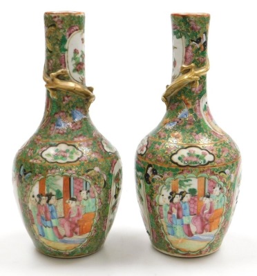 A pair of early 19thC Qing dynasty Cantonese famille rose porcelain vases, of long necked, ovoid form, gilt moulded to the neck with a lizard, decorated with reserves of birds and butterflies, and figures in an interior, within a gilt ground over decorate - 3