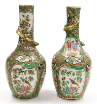 A pair of early 19thC Qing dynasty Cantonese famille rose porcelain vases, of long necked, ovoid form, gilt moulded to the neck with a lizard, decorated with reserves of birds and butterflies, and figures in an interior, within a gilt ground over decorate - 4