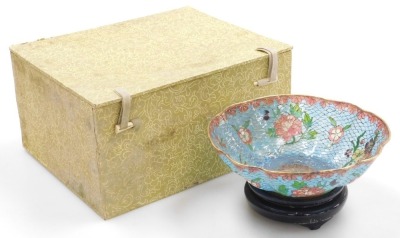 A 20thC Chinese plique-a-jour enamel bowl, of fluted form, decorated with flowers on a turquoise ground, with hardwood stand, boxed, 15cm wide, together with a cloisonne box and cover, of cylindrical form, decorated with flowers on a blue ground, boxed, 9 - 3