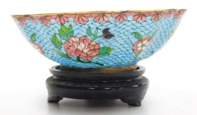 A 20thC Chinese plique-a-jour enamel bowl, of fluted form, decorated with flowers on a turquoise ground, with hardwood stand, boxed, 15cm wide, together with a cloisonne box and cover, of cylindrical form, decorated with flowers on a blue ground, boxed, 9 - 6