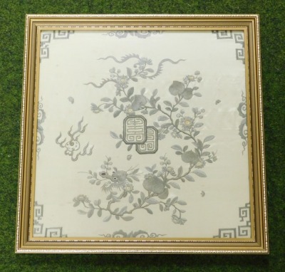 A 19thC Qing dynasty silk panel, decorated wit a peach tree, the head of a dragon, and flaming pearl, on a pale yellow ground, framed and glazed, 39.5cm high, 39cm wide. - 2