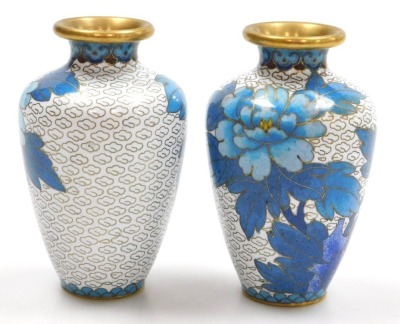 A group of 20thC Chinese cloisonne enamel wares, comprising a pair of blue ground vases decorated with prunus blossom, 12cm high, pair of white ground vases, decorated with peonies, 10cm high, and a pair of floral decorated red ground bowls, 15cm wide. (6 - 11