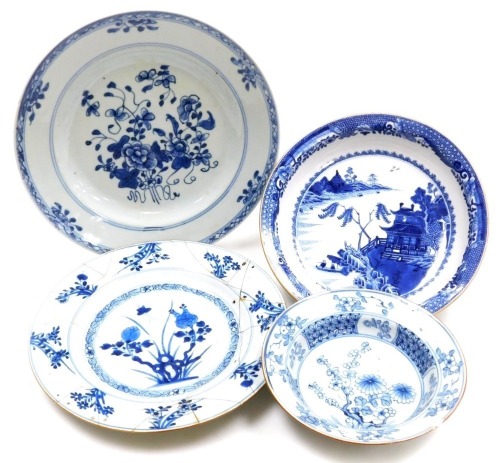 A group of Qing dynasty blue and white porcelain, 18thC and later, comprising a dish decorated with a river landscape, two plates decorated with flowers, and a dish decorated with flowers. (4, AF)