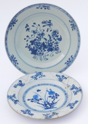 A group of Qing dynasty blue and white porcelain, 18thC and later, comprising a dish decorated with a river landscape, two plates decorated with flowers, and a dish decorated with flowers. (4, AF) - 2