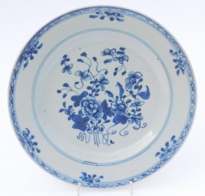 A group of Qing dynasty blue and white porcelain, 18thC and later, comprising a dish decorated with a river landscape, two plates decorated with flowers, and a dish decorated with flowers. (4, AF) - 3