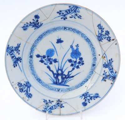 A group of Qing dynasty blue and white porcelain, 18thC and later, comprising a dish decorated with a river landscape, two plates decorated with flowers, and a dish decorated with flowers. (4, AF) - 5