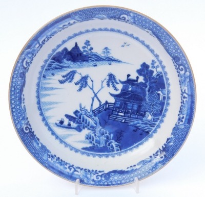 A group of Qing dynasty blue and white porcelain, 18thC and later, comprising a dish decorated with a river landscape, two plates decorated with flowers, and a dish decorated with flowers. (4, AF) - 8