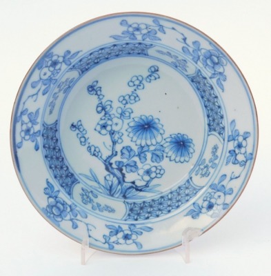 A group of Qing dynasty blue and white porcelain, 18thC and later, comprising a dish decorated with a river landscape, two plates decorated with flowers, and a dish decorated with flowers. (4, AF) - 12