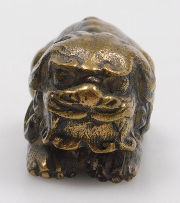 A 20thC Chinese bronze figure of a lion dog, modelled in recumbent pose, 5cm long. - 2