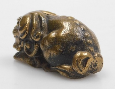 A 20thC Chinese bronze figure of a lion dog, modelled in recumbent pose, 5cm long. - 3