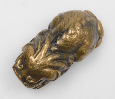 A 20thC Chinese bronze figure of a lion dog, modelled in recumbent pose, 5cm long. - 4