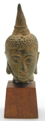 A Thai bronze head of a Buddha, possibly 17thC, raised on a wooden plinth, 9.5cm high all in. - 2