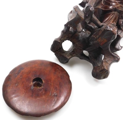 A late 19thC Qing dynasty hardwood carving of a priest, modelled standing, holding a string of beads, and a parasol, with a foliate carved hat, 35cm high. - 7