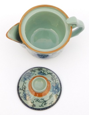 A modern Chinese pottery part tea service, decorated in blue and white with peonies against a pale blue ground, comprising a covered jug, four tea bowls, covers and saucers, and four smaller bowls, together with a metal tea strainer. - 3