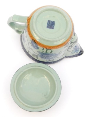 A modern Chinese pottery part tea service, decorated in blue and white with peonies against a pale blue ground, comprising a covered jug, four tea bowls, covers and saucers, and four smaller bowls, together with a metal tea strainer. - 4