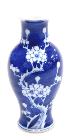 A 20th C blue and white Chinese porcelain vase, of baluster form, decorated with prunus blossom on a cracked ice ground, 17.5cm high.