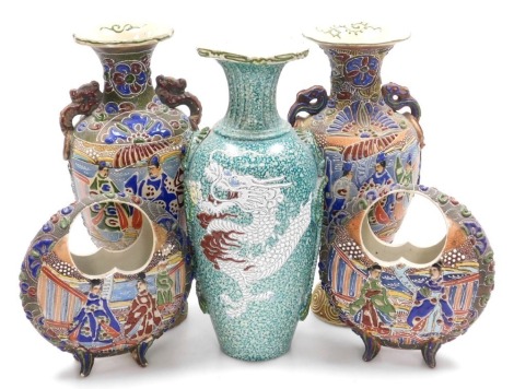 A pair of early 20thC Satsuma basket vases, of moon shaped form, decorated in moriage (raised enamels) with figures, on scroll legs, 19cm high, a pair of baluster vases similarly decorated, 32cm high, and a vase decorated with a dragon, 32cm high. (5)