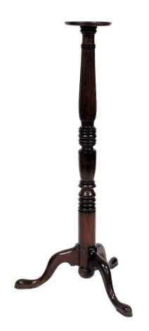 A Victorian mahogany torchère stand, the circular top on a fluted and turned column, above three cabriole legs, 137cm high.