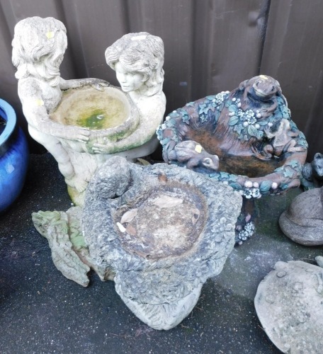 Garden statuary, to include a birdbath modelled with two figures holding a central bowl, further birdbaths, etc. (a quantity)