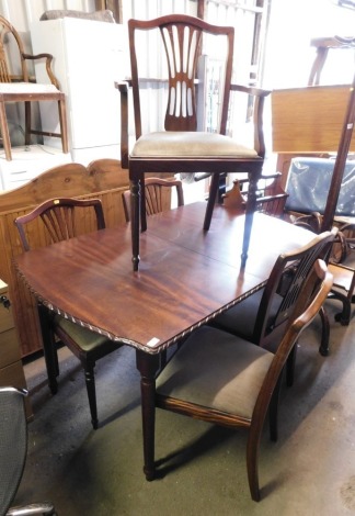 A 20thC mahogany extending dining table, 74cm high, the top 87cm x 110cm, together with five mahogany dining chairs.