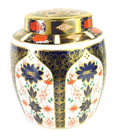 A Royal Crown Derby Old Imari porcelain jar, pattern 1128, red printed marks, and matched cover with gold ground, 22cm high, boxed.