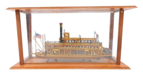 A scratch built model of a steamer boat, titled The King of Mississippi, 62cm wide, contained in a glass and wooden case, 43cm high, 87cm wide, 33cm deep.