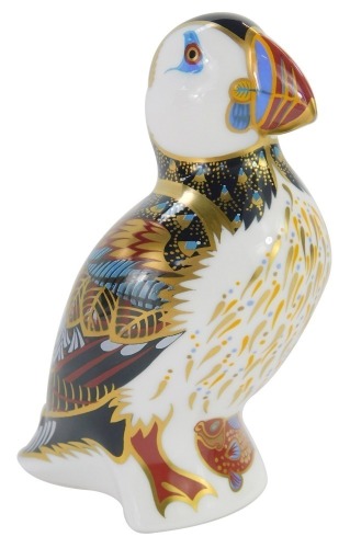 A Royal Crown Derby porcelain paperweight modelled as a puffin, gold stopper and red printed marks, 12cm high, boxed.