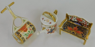 Three pieces of Royal Crown Derby Miniatures Imari porcelain, comprising Pardoe garden bench, 8cm high, Rich Japan watering can, 7cm high and Lotus Blossom garden roller, boxed. - 2