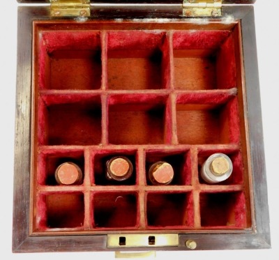 A Victorian rosewood medicine chest, the hinged lid with brass handle enclosing a red velvet lined interior with various recesses for bottles, including four glass bottles, the base with a lower drawer, with various recesses containing weights, etc., 19.5 - 2