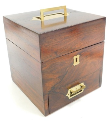 A Victorian rosewood medicine chest, the hinged lid with brass handle enclosing a red velvet lined interior with various recesses for bottles, including four glass bottles, the base with a lower drawer, with various recesses containing weights, etc., 19.5 - 3