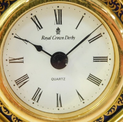 A Royal Crown Derby Old Imari porcelain desk clock, gold ground, pattern 1128, the circular dial bearing Roman numerals, quartz movement, red printed marks, 11cm high, boxed. - 2