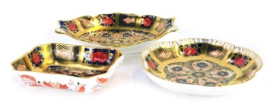 Three Royal Crown Derby Old Imari porcelain trinket dishes, each gold ground, pattern 1128, comprising dish with rectangular shaped form, 9.5cm wide, flower head form, 11cm diameter, and shaped oval two handled dish, 13.5cm wide, each boxed.