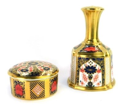 A Royal Crown Derby Old Imari porcelain hand bell, gold ground, pattern 1128, 14cm high, boxed, together with a Royal Crown Derby Old Imari porcelain circular trinket dish and cover, gold ground, pattern 1128, 8.5cm diameter, boxed. (2)