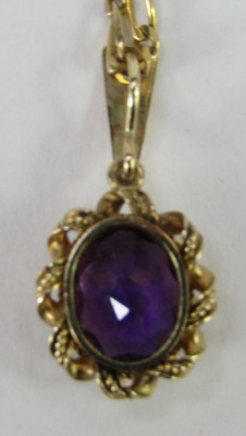 An amethyst pendant and chain, the oval amethyst pendant in a rope twist border, 2.5cm high, on a byzantine link neck chain, 40cm long, stamped 9kt, 5g all in. - 3