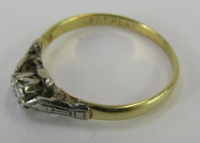 A diamond solitaire dress ring, the tiny diamond in claw setting, with white metal shoulders, on yellow metal band, stamped 18t plat, ring size O½, 1.7g all in. - 2