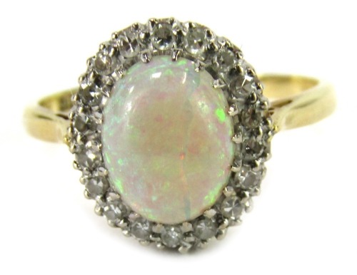 An Elizabeth II 18ct gold opal and diamond dress ring, the oval cabochon opal in claw setting surrounded by tiny diamonds, on a plain band, Birmingham 1962, ring size O½, 3.5g all in. (the opal AF)